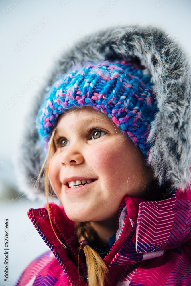Portrait of a young girl playing in the snow. Portrait of a young girl playing in the snow.