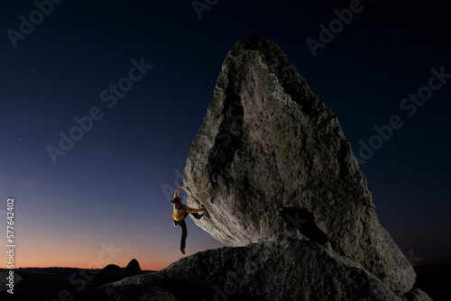 Climber climbing on boulder at in Valley of Frogs near Creel, Chihuahua, Mexico