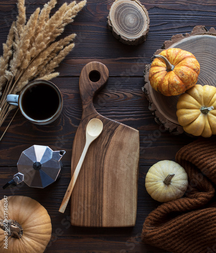 Wooden table with pumpkins, coffee and blankets
