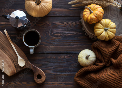 Wooden table with pumpkins and coffee