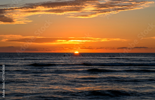 Maui  Hawaii sunset with surfers