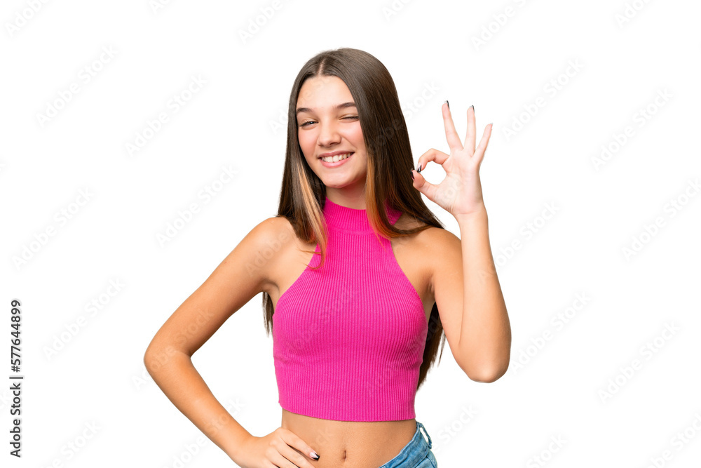 Teenager caucasian girl over isolated background showing ok sign with fingers Teenager caucasian girl over isolated background showing ok sign with fingers