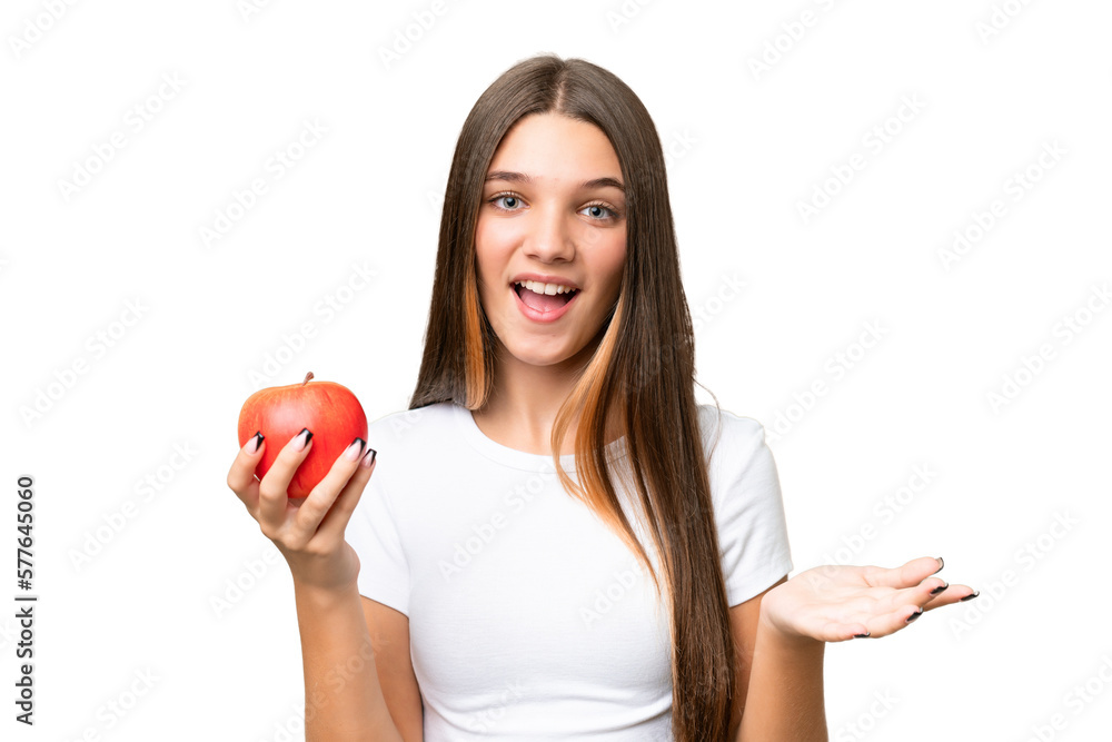 Teenager caucasian girl holding an apple over isolated background with shocked facial expression Teenager caucasian girl holding an apple over isolated background with shocked facial expression