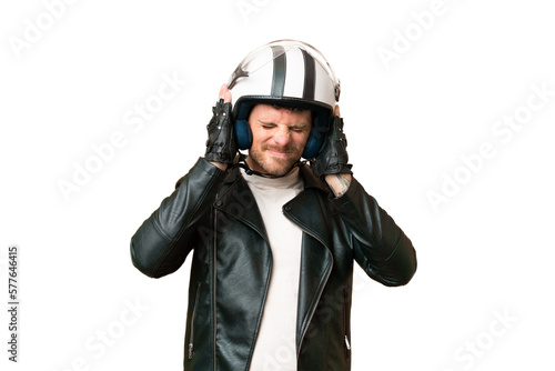 Brazilian man with a motorcycle helmet over isolated chroma key background frustrated and covering ears