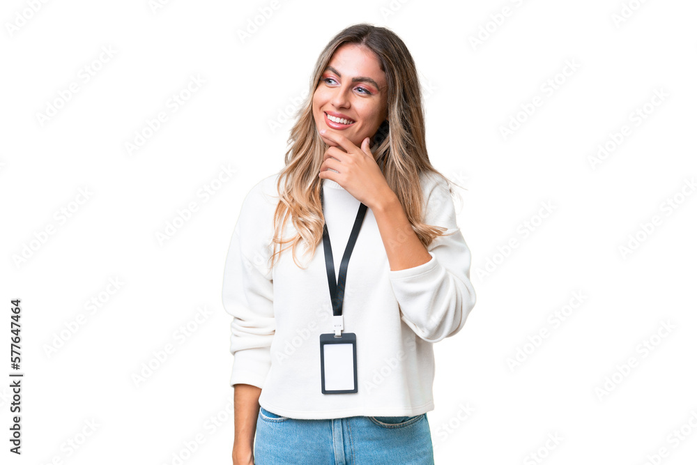 Young Uruguayan woman with ID card over isolated background looking to the side and smiling Young Uruguayan woman with ID card over isolated background looking to the side and smiling