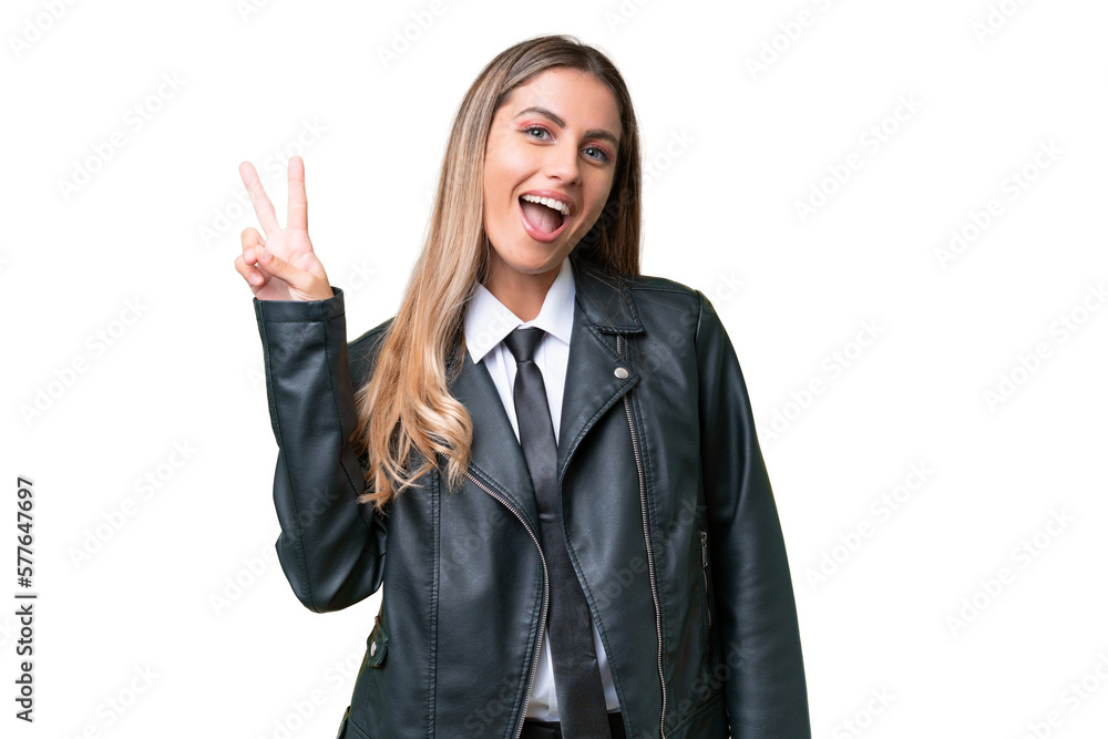 Business pretty Uruguayan woman wearing a biker jacket over isolated background smiling and showing victory sign Business pretty Uruguayan woman wearing a biker jacket over isolated background smiling and showing victory sign