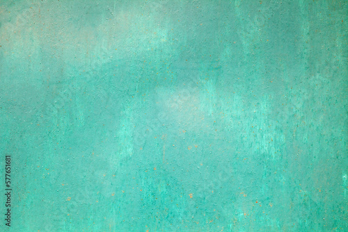 Roughly painted with green paint metal surface, background wallpaper, uniform texture pattern