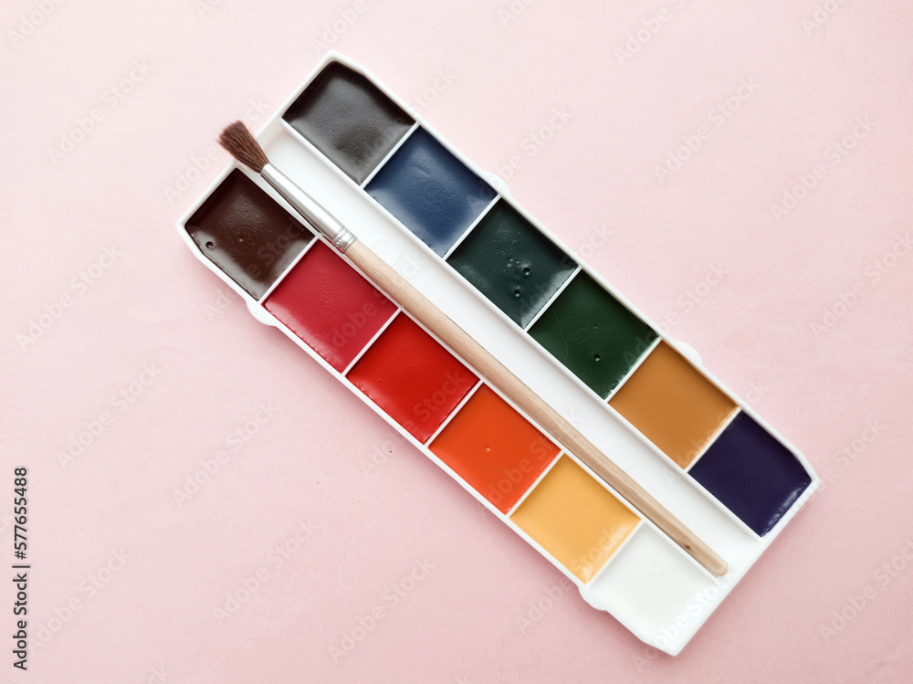 Brush and paint on a white background. Everything for drawing. Creation. Children is creativity. Hobby. Colored paints and gouache. Brush and paint on a white background. Everything for drawing. Creation. Children is creativity. Hobby. Colored paints and gouache.