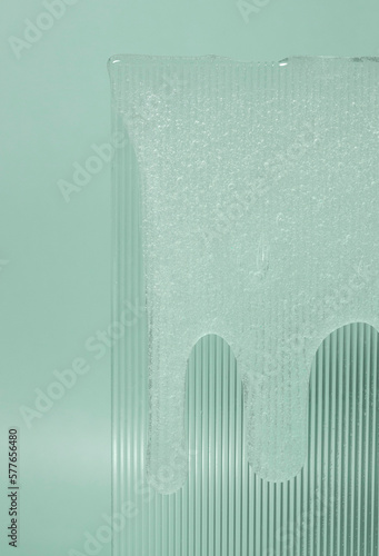 Cosmetic lotion transparent gel flow down  texture on green background
