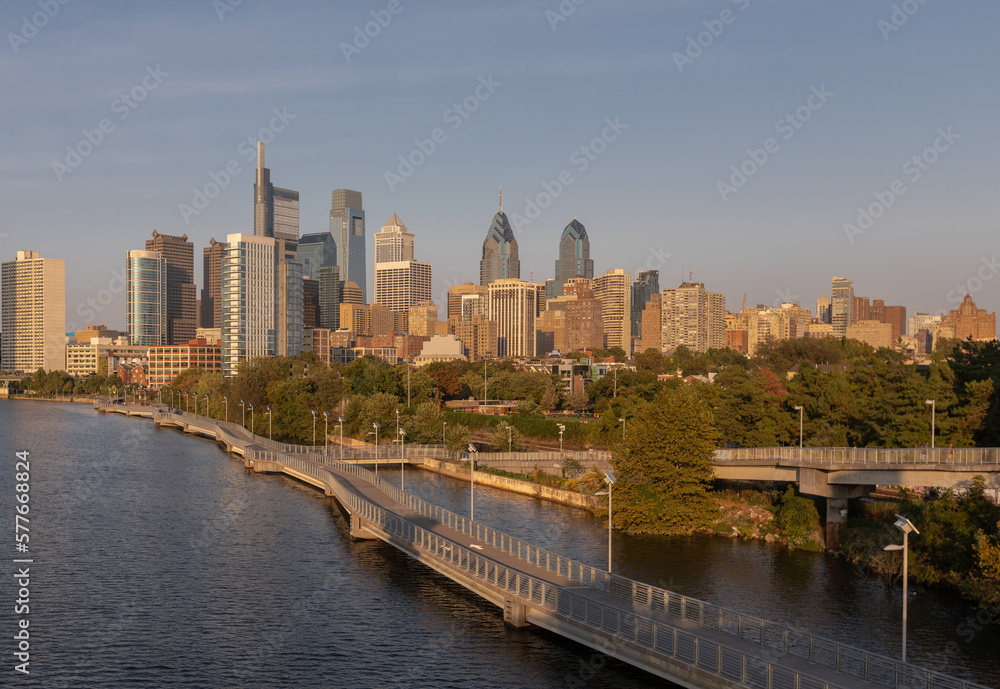 Philadelphia Downtown skyline with the Schuylkill river. Beautiful Sunset Light. Schuylkill River Trail in Background. City skyline glows under the beautiful sunset light