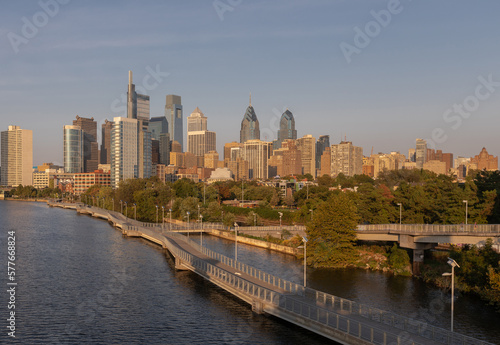 Philadelphia Downtown skyline with the Schuylkill river. Beautiful Sunset Light. Schuylkill River Trail in Background. City skyline glows under the beautiful sunset light