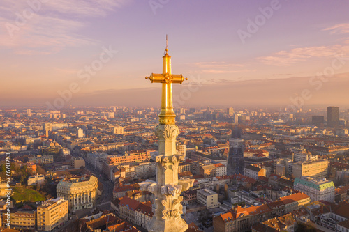 Golden Cross of Zagreb Cathedral in Croatia. It is on the Kaptol, is a Roman Catholic institution and the tallest building in Croatia. Sacral building in Gothic style. Cityscape in Background