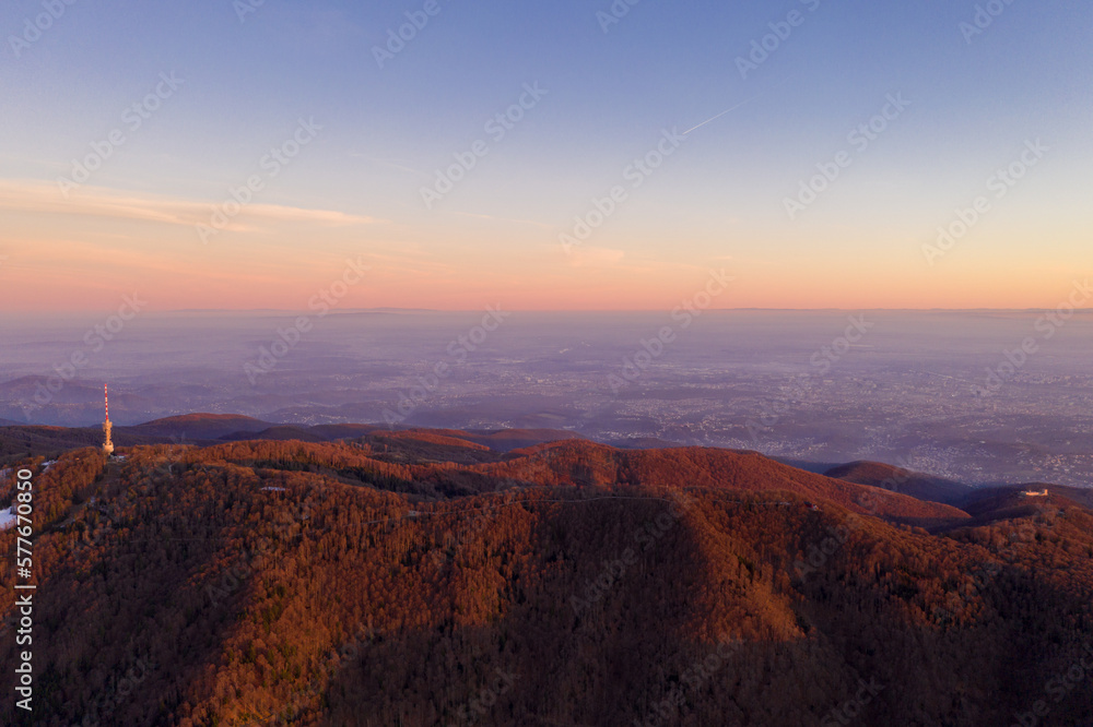 Zagreb Skyline in Croatia. TV Tower, Sunset Light Colorful Sky in Background. View from the top of Medvednica Mountain. Haze Background.