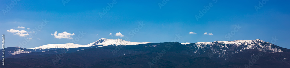 Amazing panorama with snow-capped mountains and hills