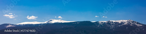 Amazing panorama with snow-capped mountains and hills