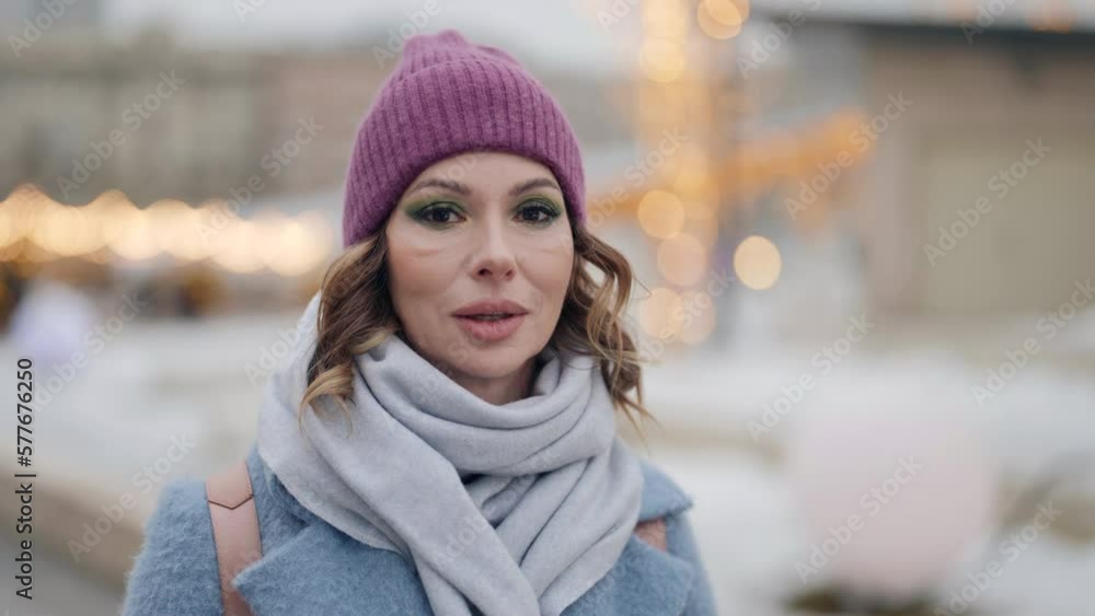 beautiful middle-aged woman walking in downtown in winter day, portrait in Christmas holidays beautiful middle-aged woman walking in downtown in winter day, portrait in Christmas holidays
