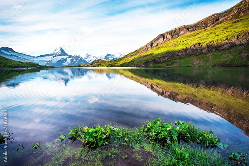 Breathtaking beautiful scenery on the lake in the Swiss Alps. Wetterhorn, Schreckhorn, Finsteraarhorn et Bachsee. Exciting places. (relaxation, harmony, anti-stress - concept).