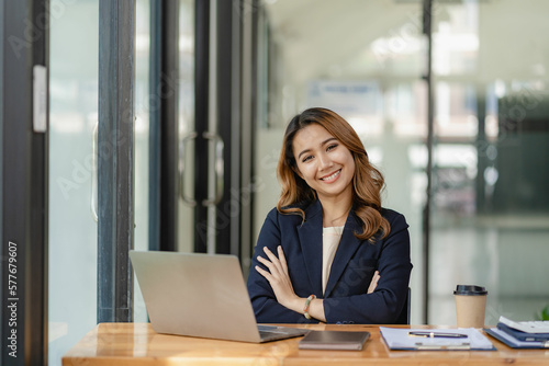 Asian female entrepreneur who uses a calculator to do calculations. Business performance documents of accounting firms, auditors, freelance, finance and investment Tax calculation and budget each year