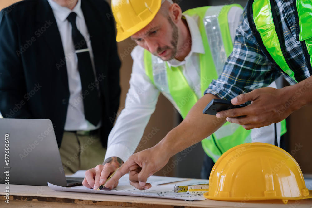 Architect team and Colleagues mixed race, Male engineers or business partners on a construction site, discussing project details. Architect team and Colleagues mixed race, Male engineers or business partners on a construction site, discussing project details.
