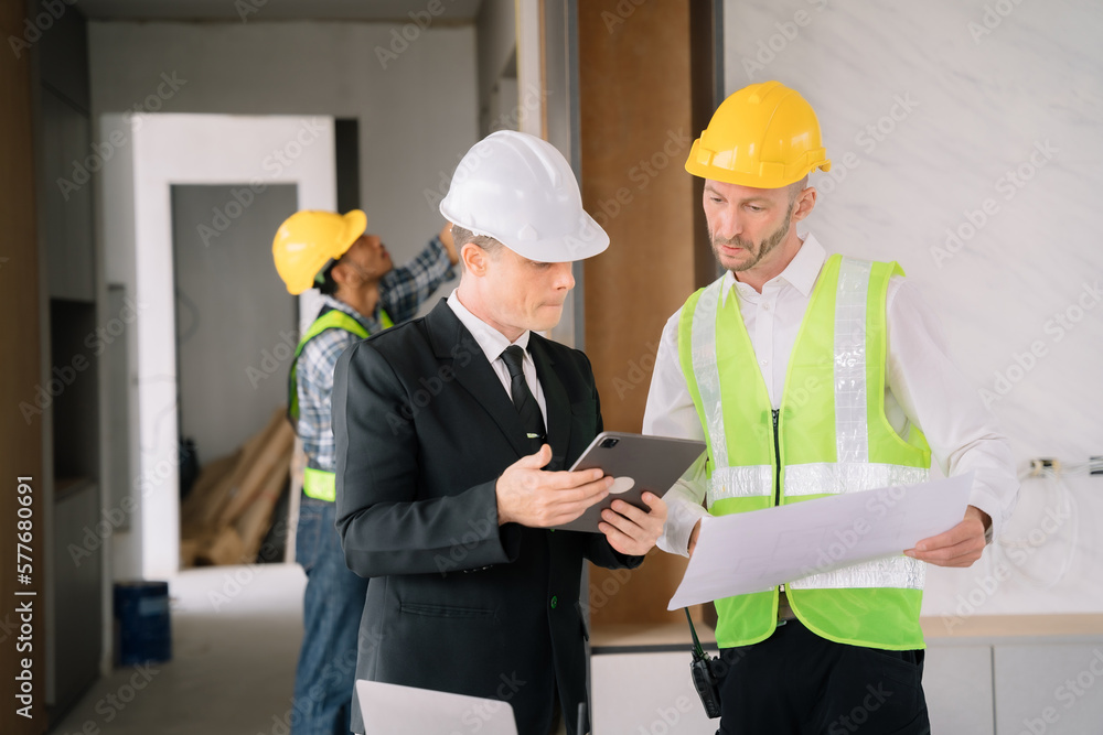 Colleagues mixed race, Group architect team on construction site inspection documents and business workflow in the morning. Colleagues mixed race, Group architect team on construction site inspection documents and business workflow in the morning.