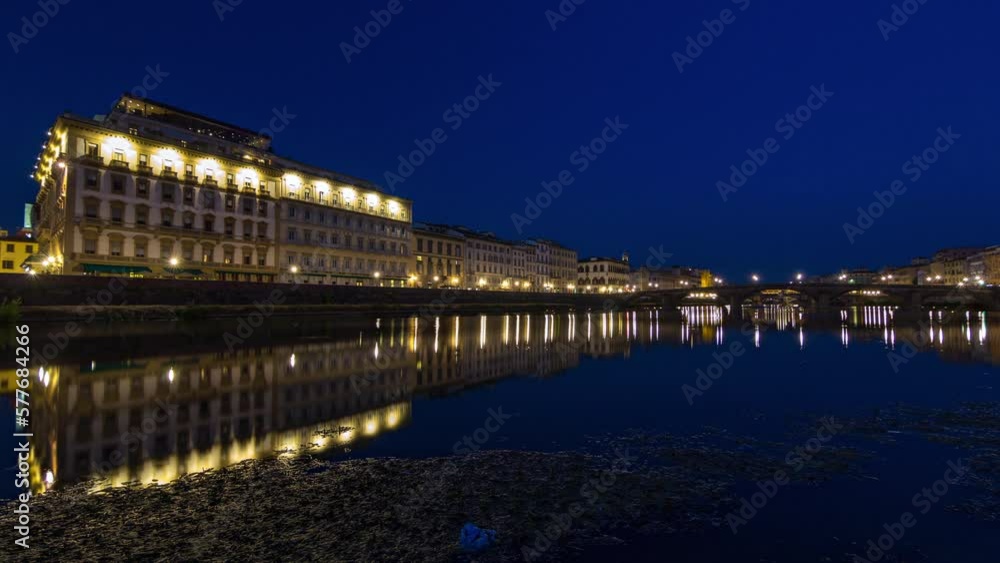Twilight scene of Ponte Alla Carraia and and illuminated historical buildings day to night transition timelapse over River Arno with reflections on water after sunset. Florence, Tuscany, Italy Twilight scene of Ponte Alla Carraia and and illuminated historical buildings day to night transition timelapse over River Arno with reflections on water after sunset. Florence, Tuscany, Italy