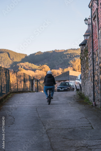 Wallpaper Mural 40 year old woman riding her electric scooter through the streets of the city (Concept of electric mobility) Torontodigital.ca