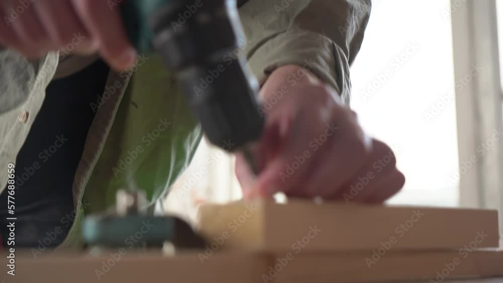 male craftsman works in a workshop with wood. power tool. close-up. male craftsman works in a workshop with wood. power tool. close-up.
