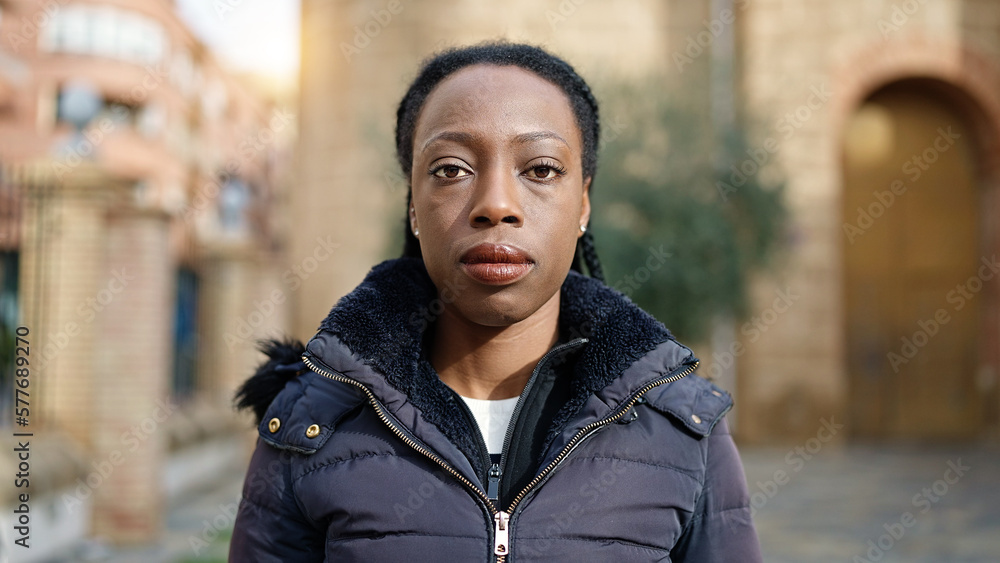 African american woman standing with serious expression at street African american woman standing with serious expression at street
