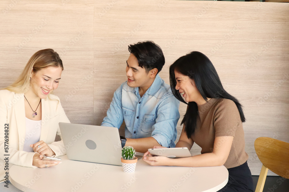 Happiness at work. Multiethnic happy business people sitting and discussing in office, best collaboration concept for work Happiness at work. Multiethnic happy business people sitting and discussing in office, best collaboration concept for work
