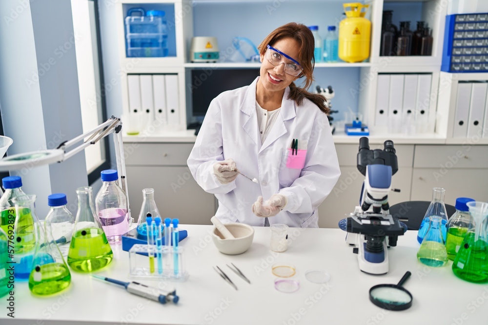 Young latin woman wearing scientist uniform working at laboratory Young latin woman wearing scientist uniform working at laboratory