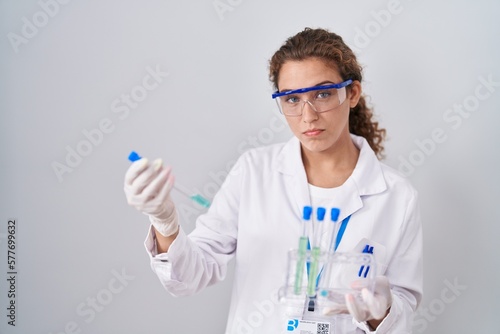 Young caucasian scientist woman working with laboratory samples depressed and worry for distress  crying angry and afraid. sad expression.