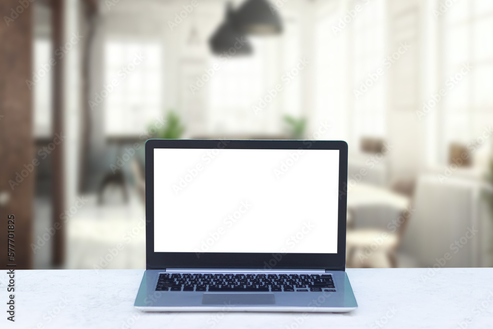 Laptop computer on desk at office or co-working space, Laptop with white blank on screen and blurred background , working space concept. Laptop computer on desk at office or co-working space, Laptop with white blank on screen and blurred background , working space concept.