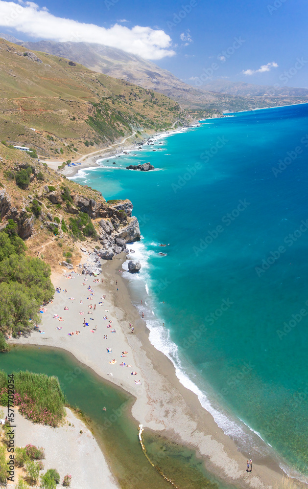 View of famous Preveli palm beach, Rethymno, southern Crete, Greece. The beach is at the point where a wide gorge meets the turquoise waters of Cretan Sea, in the Mediterranean.