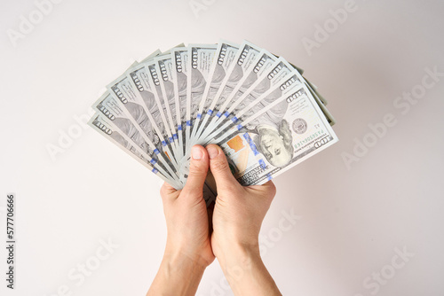 Hands holding Dollar money bills, white background, close-up