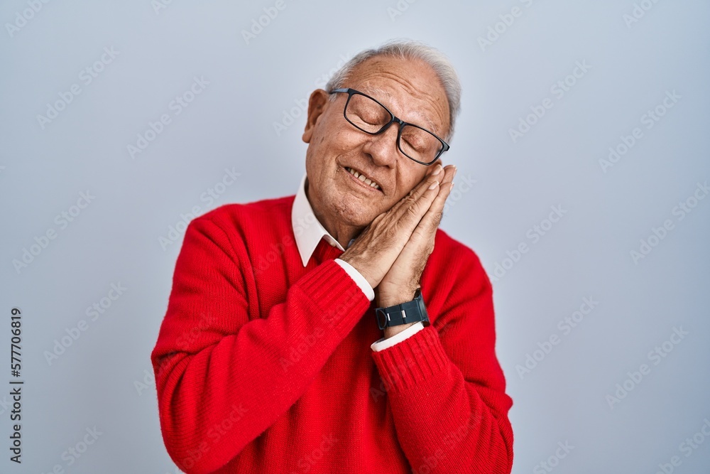 Senior man with grey hair standing over isolated background sleeping tired dreaming and posing with hands together while smiling with closed eyes. Senior man with grey hair standing over isolated background sleeping tired dreaming and posing with hands together while smiling with closed eyes.