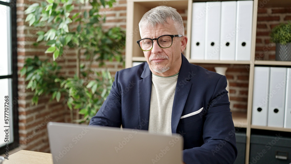 Fototapeta premium Middle age grey-haired man business worker using laptop working at office
