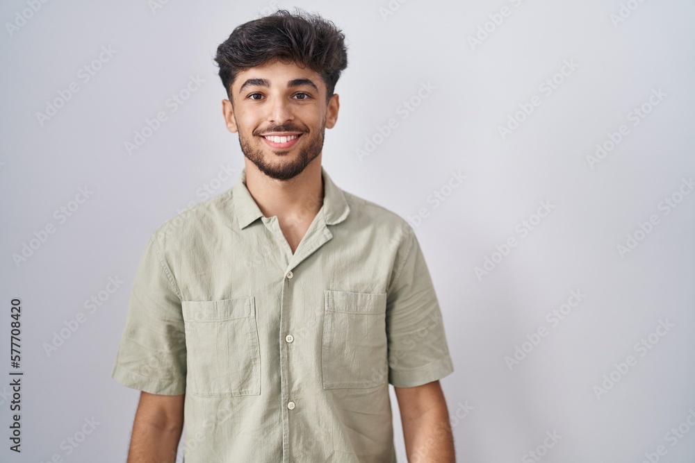 Arab man with beard standing over white background with a happy and cool smile on face. lucky person. Arab man with beard standing over white background with a happy and cool smile on face. lucky person.