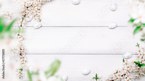 Easter background wood. Sakura blossom flower, white happy easter eggs on wood spring background. Easter design. Top view. Flat lay.