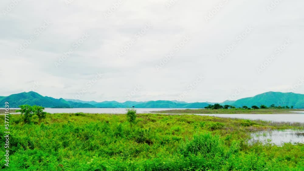 The atmosphere along the dam in the morning saw the river and green mountains in the background. The atmosphere along the dam in the morning saw the river and green mountains in the background.