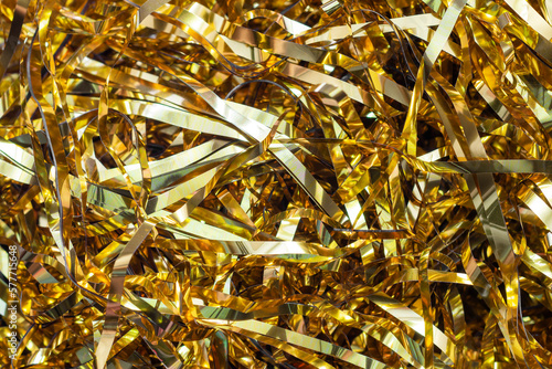 Festive gold tinsel strands. Glistening web banner or background for your design