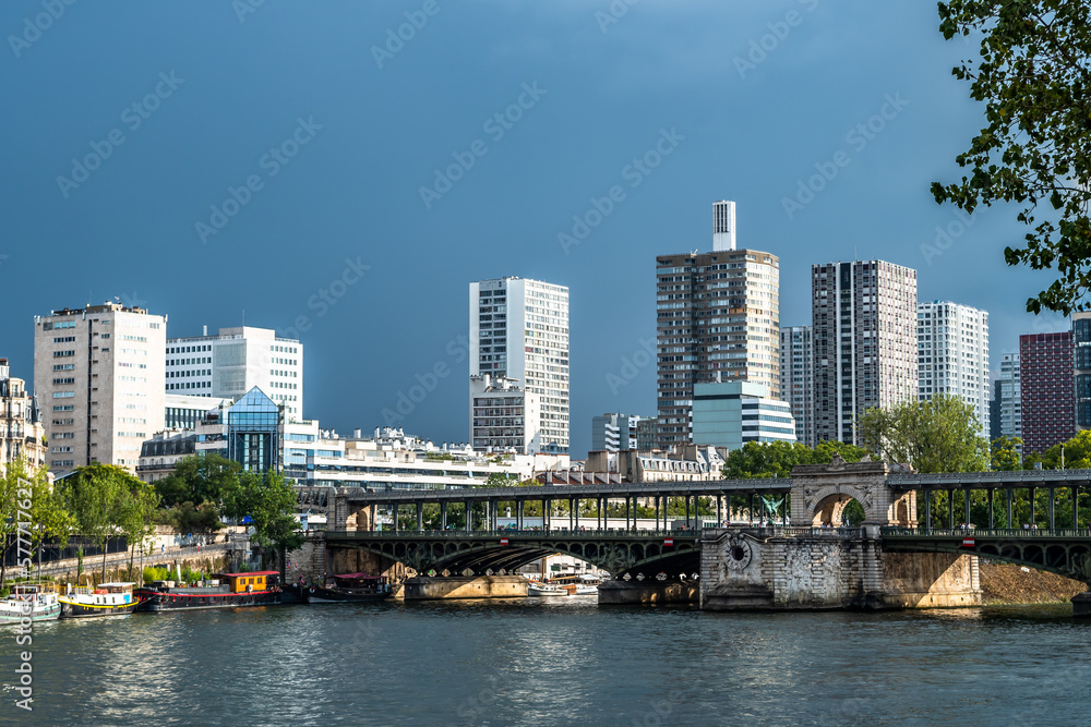 Naklejka premium River Seine In Paris, France With Promenade, Anchored Houseboats And Modern Office Buildings
