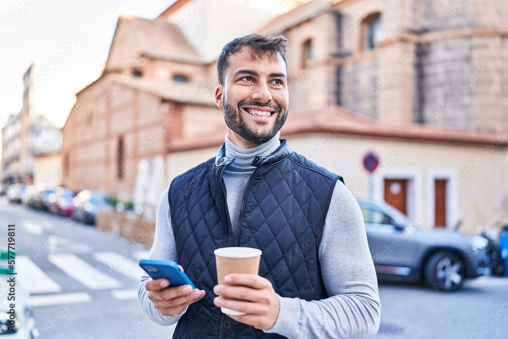 Young hispanic man using smartphone drinking coffee at street Young hispanic man using smartphone drinking coffee at street