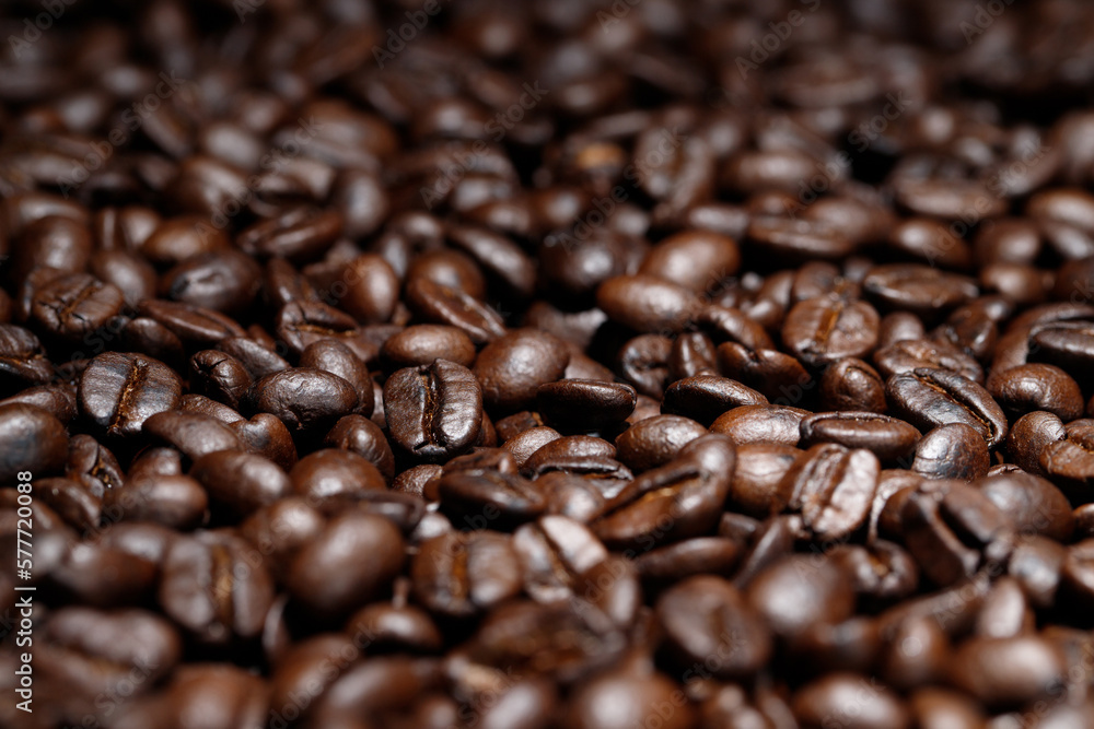 Freshly roasted coffee beans in a cup Freshly roasted coffee beans in a cup