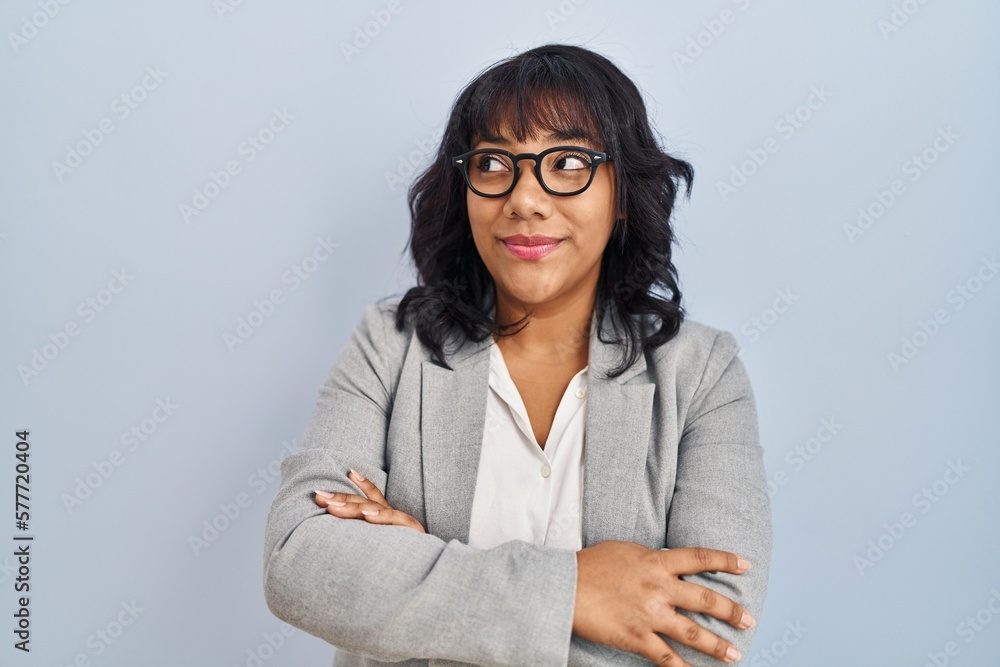 Hispanic woman standing over isolated background smiling looking to the side and staring away thinking. Hispanic woman standing over isolated background smiling looking to the side and staring away thinking.