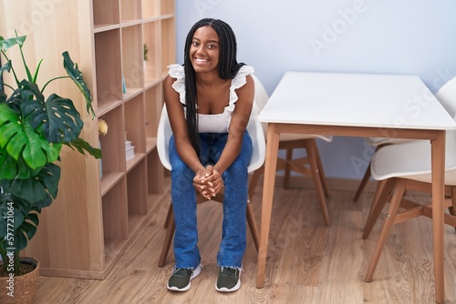 African american woman smiling confident sitting on chair at home