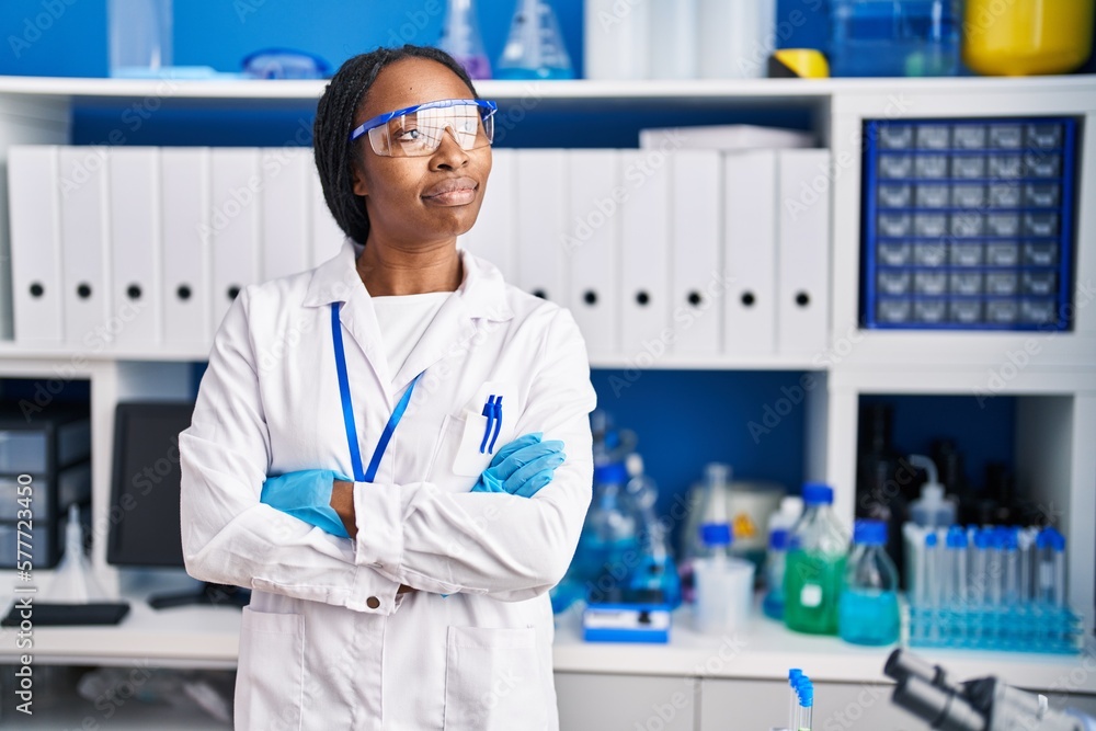 African american woman wearing scientist uniform standing with arms crossed gesture laboratory African american woman wearing scientist uniform standing with arms crossed gesture laboratory