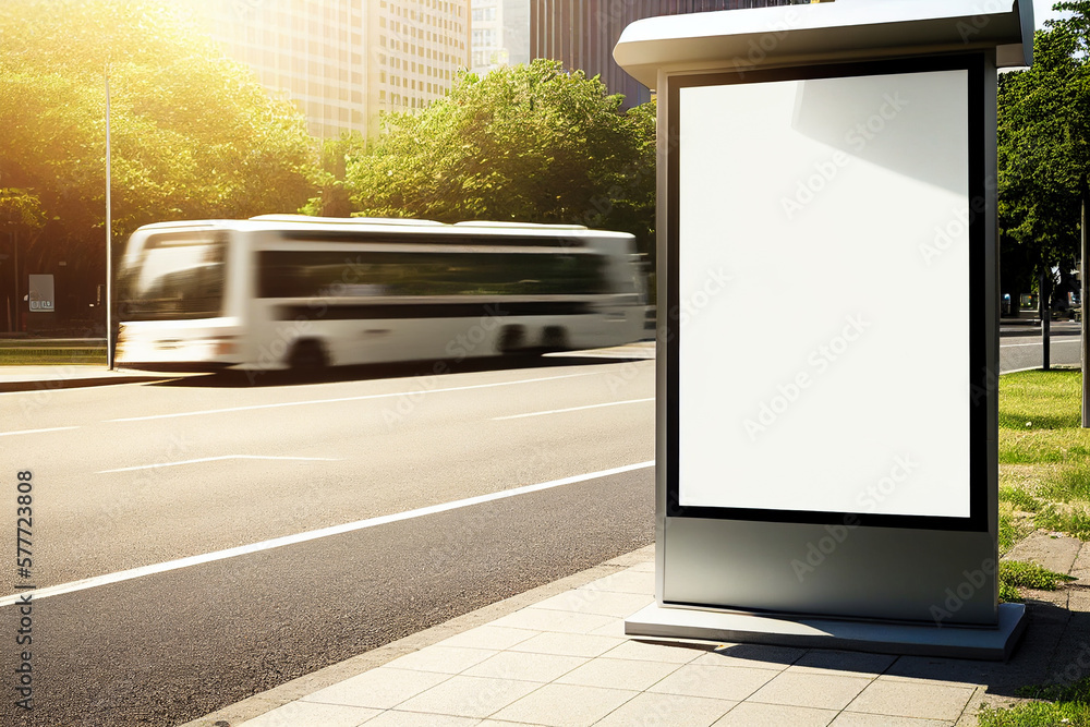 Vertical blank white billboard at bus stop on city street. Mock up billboard for advertising, promotion and marketing of products and events.
In the background buildings and road. 