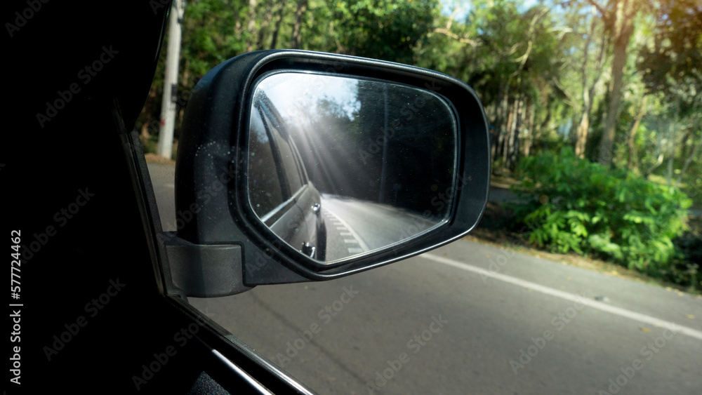 Obraz premium Car on the road drive to nature,Travel to clear the province, Beside with green of nature speed, Focus to mirror view backside.