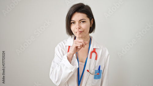 Young caucasian woman doctor asking for silent over isolated white background