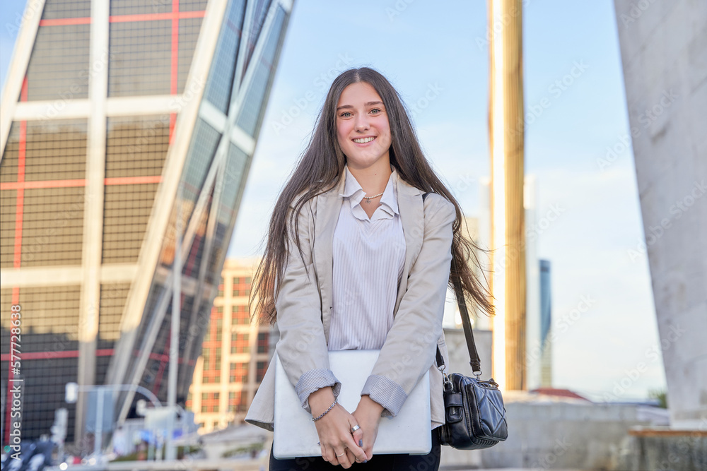 businesswoman smiling with laptop in hand businesswoman smiling with laptop in hand